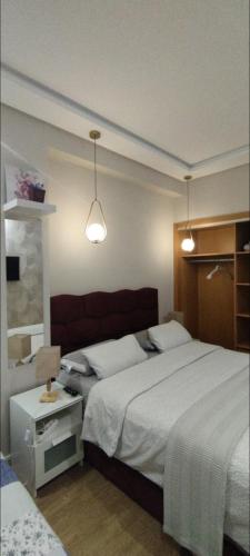 a bedroom with two beds and two lights at infinity by Ghita in Rabat