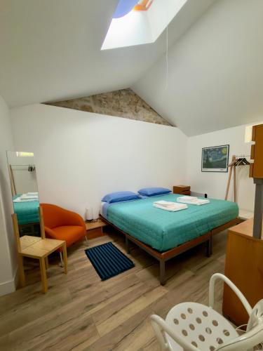 a bedroom with a bed and a chair at Casa da Granja in Sobral de Monte Agraço