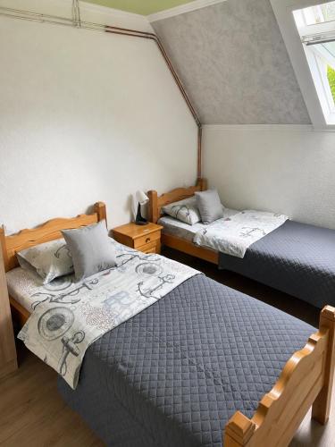 a bedroom with two beds and a window at Gorštak in Žabljak