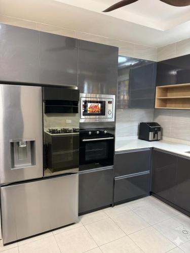 a kitchen with stainless steel appliances in a kitchen at Asibbey Lodge in Ashalebotwe
