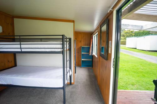 a bunk bed room with two bunk beds in it at Welcome Bay Hot Pools in Tauranga