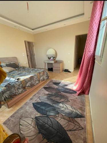 a bedroom with a bed and a rug on the floor at فيلا رامي رزق Luxury villa with private pool& complete privacy in 6th Of October