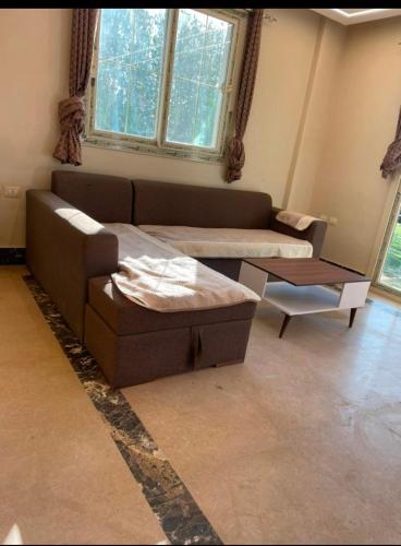 a living room with a couch and a table at فيلا رامي رزق Luxury villa with private pool& complete privacy in 6th Of October