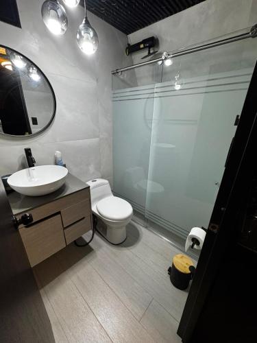 a bathroom with a toilet and a sink and a shower at Cabaña Nivura in Palmira