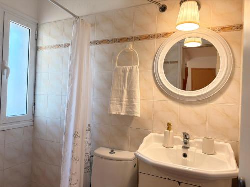 a bathroom with a toilet and a sink and a mirror at Studio 28 in Chios