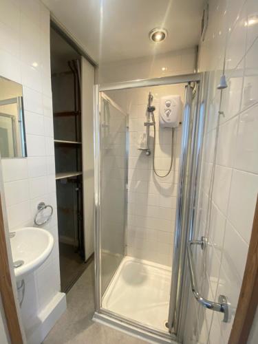 a bathroom with a shower and a sink at The Nest Chelmsford in Chelmsford