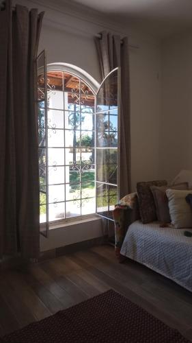 a bedroom with a bed and a large window at Life Pinhalzinho in Pinhalzinho