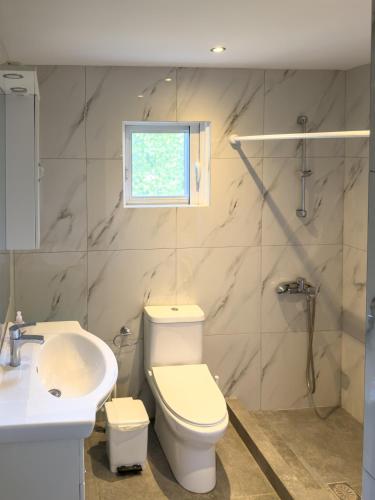 a bathroom with a toilet and a sink at Modern Comfort Apartment - Arkitsa Rentals in Arkitsa