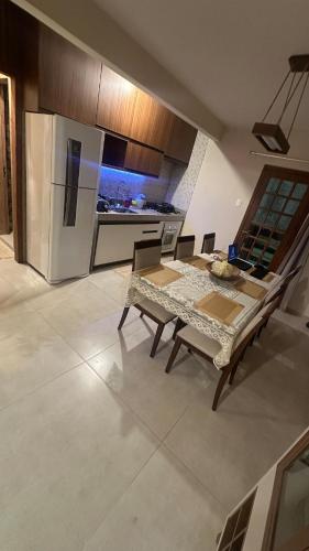 a kitchen with a table and chairs and a refrigerator at Recanto HipoMar in Marechal Floriano
