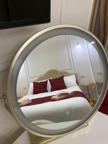 a bedroom with a mirror with a bed in it at Gaglian's Suites Lake Como in Como