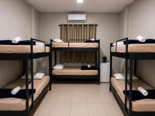 a room with four bunk beds in a dorm at Riacho Hotel in Brasília
