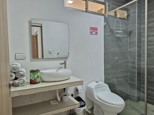 a bathroom with a toilet and a sink and a shower at Casa Playa Arreboles in Cartagena de Indias