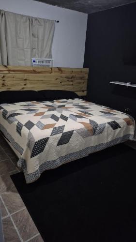 a bed with a quilt on it in a room at Portobelo in San Juan