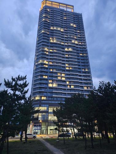 a tall building with lights on the side of it at Emerson Suites Naksan in Yangyang