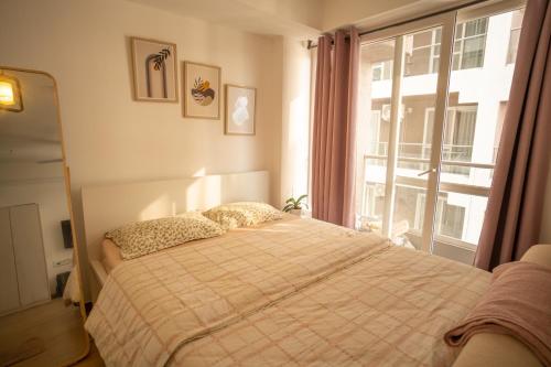a bedroom with a bed and a window at Casa Lucia in Pune