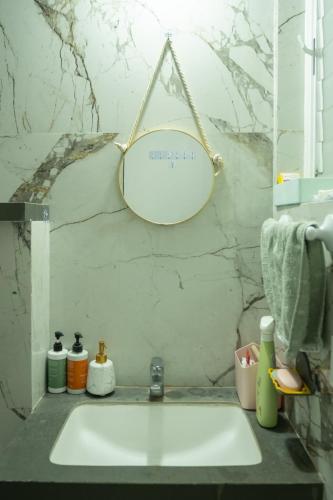 a bathroom sink with a mirror hanging above it at Casa Lucia in Pune