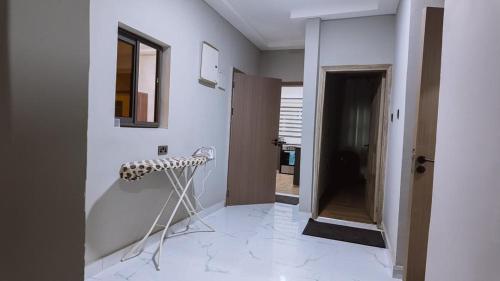 a room with a hallway with white walls and a door at The Rehoboth in Sakumona