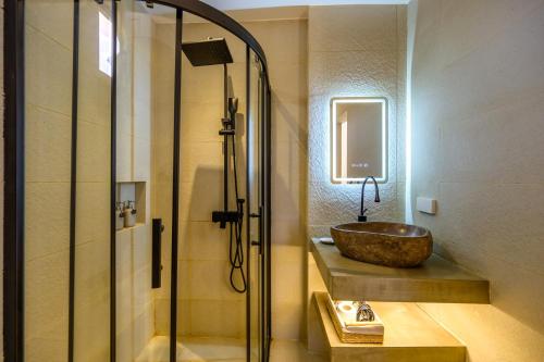 a bathroom with a sink and a glass shower at Go Boutique Inn in Puerto Princesa City