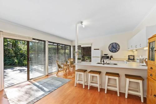 a kitchen with a counter and some chairs in a room at The Treehouse at Long Beach in Long Beach