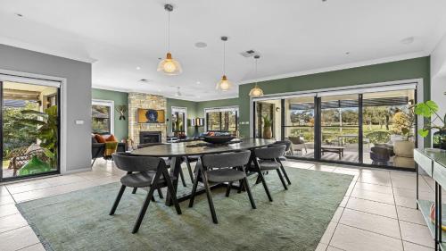 a dining room with a table and chairs at Hunter Grange - The Vintage in Pokolbin