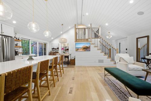 a kitchen and living room with a bar and a staircase at Loma House in Sawyer