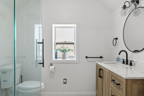 a bathroom with a shower and a toilet and a sink at Riverview Bliss in Beautiful Home in Pulaski
