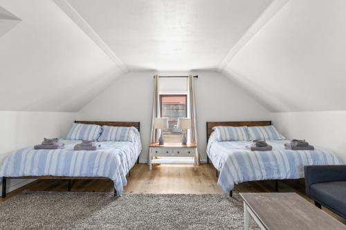 a attic bedroom with two beds and a couch at Riverview Bliss in Beautiful Home in Pulaski
