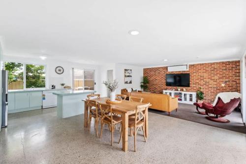 a kitchen and living room with a table and chairs at Light and Bright at Maloneys in Maloney's Beach
