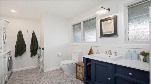 a bathroom with a sink and a toilet at 19 Newry St in Nambucca Heads