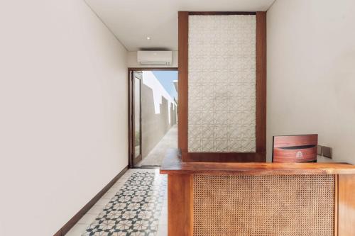 a room with a door and a hallway with a floor at Ayona Villa Seminyak by Ini Vie Hospitality in Seminyak