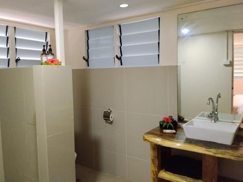 a bathroom with a sink and a mirror at Likuri Island Resort Fiji in Natadola