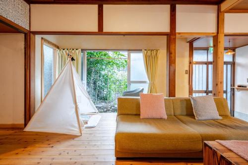 a living room with a couch and a hammock at The Sticks Inatori in Higashiizu
