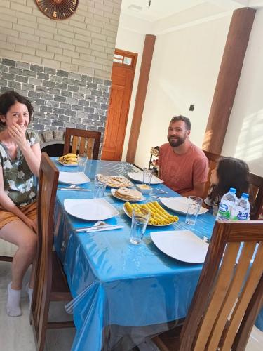 a group of people sitting around a table at Ohiya Alpine River Lodge in Ohiya