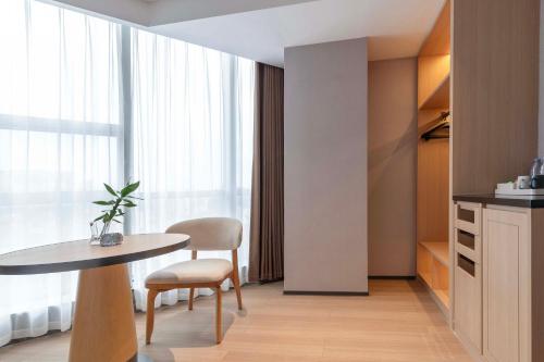 a room with a table and chairs and a window at YIBON INTERNATIONAL HOTEL in Guiyang