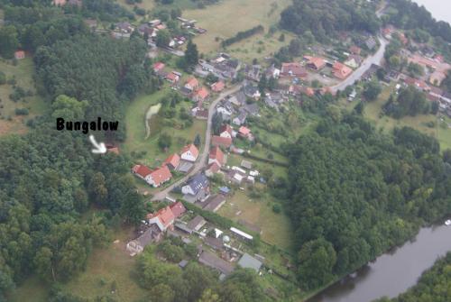 an aerial view of a house on a hill next to a river at Wald&Wiesengeflüster Zechlinerhütte in Rheinsberg