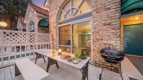 a grill on a patio with a table on a balcony at Taean Atirans Beach Pension in Taean