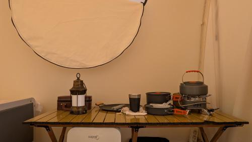 a wooden table with pots and pans on it at Guest House of Issyk-Kul Camp in Chok-Tal