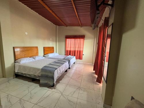 a bedroom with a large bed and a window at Amarena Resorts in Bocapán
