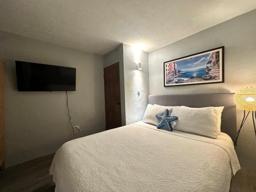 a hotel room with a bed with a blue bow on it at Gema del Mar, Vieques, PR in Vieques