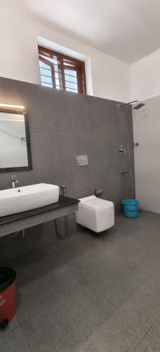 a bathroom with a sink and a mirror at Hotel Neptune Kovalam in Trivandrum