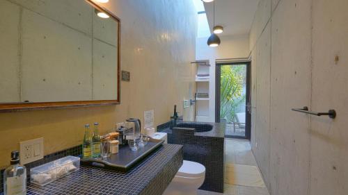 a bathroom with a sink and a toilet and a mirror at Cuna del Cielo in San Miguel de Allende