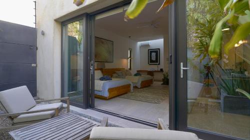 a living room with a bed and a sliding glass door at Cuna del Cielo in San Miguel de Allende