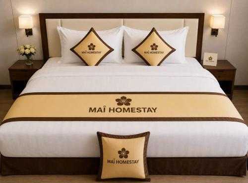 a large bed with two pillows on top of it at Mai Homestay in Ninh Binh