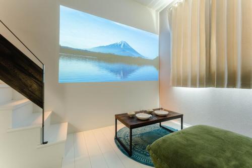 a bedroom with a table with a view of a mountain at iisa307 in Isahaya