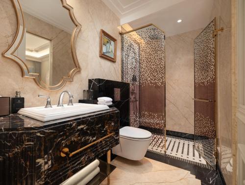 a bathroom with a toilet sink and a shower at Classyc Hotel Hang Buom in Hanoi