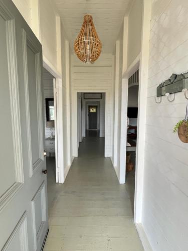 a hallway of a home with a chandelier at Oakmore Cottage Charming Old Vintage Queenslander - Central location in Bundaberg