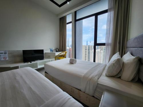 a hotel room with two beds and a large window at KLCC Expressionz by WGS, 300Mbps WiFi in Kuala Lumpur