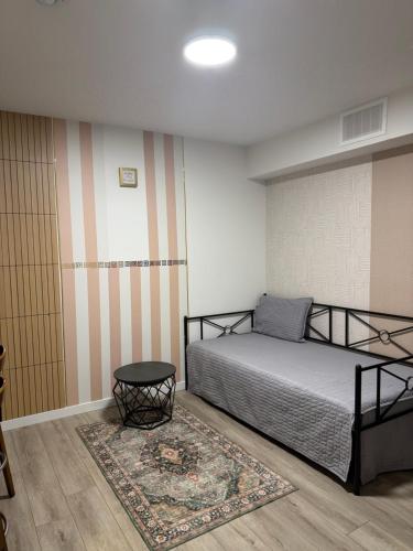 a bedroom with a bed and a rug at Haverims Cozy and Neat Basement in Edmonton