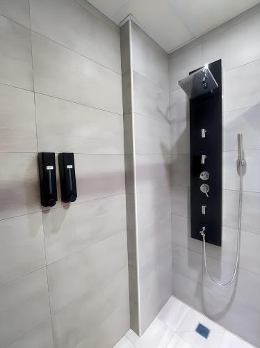 a bathroom with a shower with a glass door at 雀居民宿 in Yuli