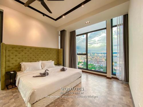 a bedroom with a large bed with a large window at WGS Suites at KLCC, 300Mbps WiFi in Kuala Lumpur